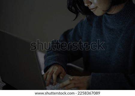Woman using a computer in the dark
 Royalty-Free Stock Photo #2258367089