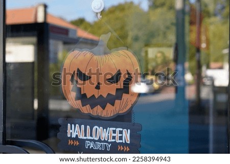 Halloween Party text sign on door shop with scary faced pumpkins orange in holiday design banner