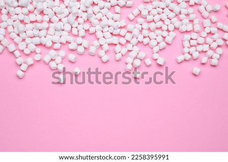 Delicious sweet marshmallows on pink background, flat lay. Space for text