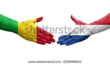 Handshake between Mali and Netherlands flags painted on hands, isolated transparent image.