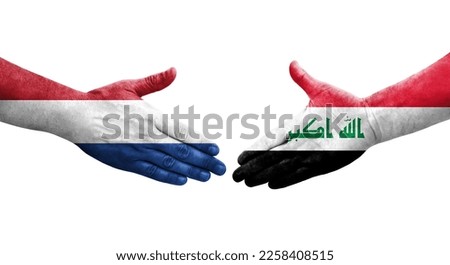 Handshake between Iraq and Netherlands flags painted on hands, isolated transparent image.