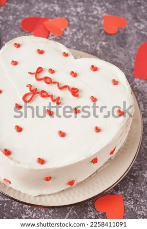 Plate with heart-shaped bento cake on grey background, closeup. Valentine's Day celebration