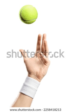 Male hand with a wristband throwing a tennis ball isolated on white background Royalty-Free Stock Photo #2258418213