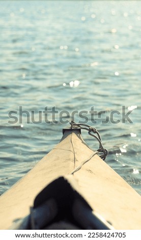 Close up front of boat and shimmering water concept photo. Sailing in river. Front view photography with blurred background. High quality picture for wallpaper, travel blog, magazine, article