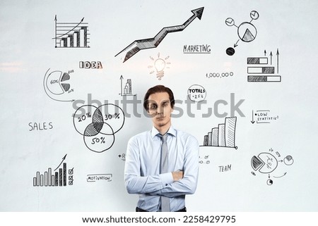 Solution, decision, analysis and creative idea concept with handsome man crossing hands on light wall with hand written stats indicators, graphs and light bulb background Royalty-Free Stock Photo #2258429795
