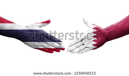 Handshake between Qatar and Thailand flags painted on hands, isolated transparent image.