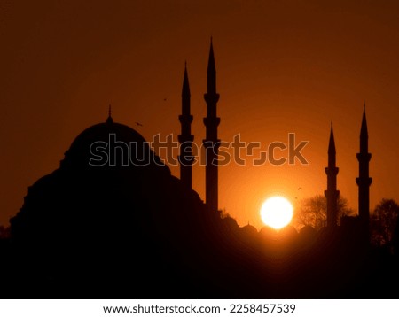 Suleymaniye Mosque silhouette, one of the unique symbols of Istanbul, at sunset. Ramadan themed iftar and evening prayer.