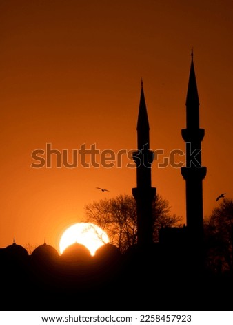 Mosque minarets silhouette, one of the unique symbols of Istanbul, at sunset. Ramadan themed iftar and evening prayer.