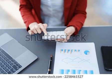 financial, Planning, Marketing and Accounting, portrait of Asian employee checking financial statements using documents and calculators at work.
