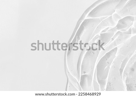 Transparent serum or gel with hyaluronic acid for the face on a white background. Textured background with oxygen bubbles. Wellness and beauty concept. Royalty-Free Stock Photo #2258468929