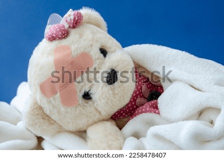 Child injury prevention. Toy bear with a medical bandage