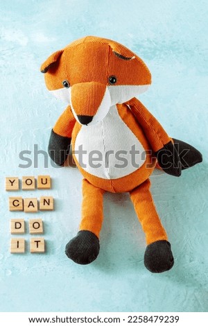 You can do it, inspirational banner with a toy fox on a blue background, the concept of encouragement