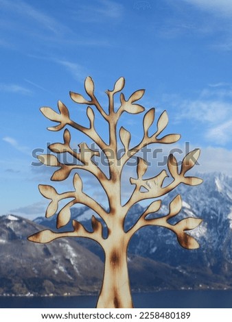 tree made of wood with winterlandscape in Austria as background
