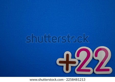 Colorfully written +22 text on the lower right side of the blue background.