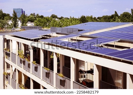 Solar Panels on Roof of Apartment Building. Solar Energy System of Modern High-rise Building.  Royalty-Free Stock Photo #2258482179