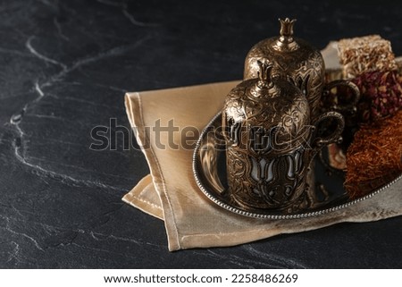 Tea and Turkish delight served in vintage tea set on dark grey textured table, space for text