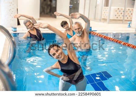 Group of seniors having aqua aerobics class Royalty-Free Stock Photo #2258490601