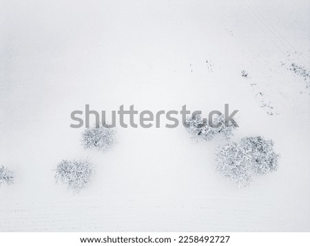 Aerial view, top down, land covered with a heavy blanket of snow