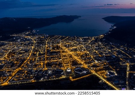 Night view of Magadan from a height. Big city in the Far East of Russia. The administrative center of the Magadan region. Many buildings and beautiful street lighting in the dusk. Royalty-Free Stock Photo #2258515405