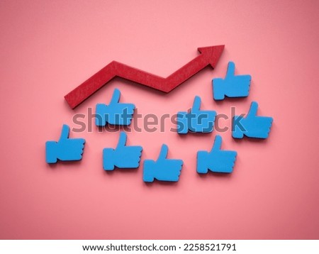 Like symbols and rising arrow as concept of popularity in social media. Royalty-Free Stock Photo #2258521791