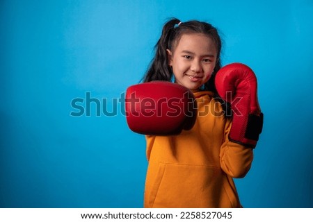 the studio isolated a portrait image of the girl wearing the boxing gloves