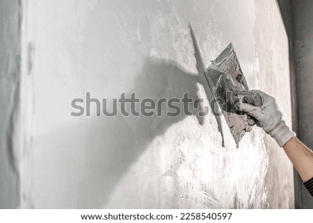 application of insulation to the wall against moisture and water Royalty-Free Stock Photo #2258540597