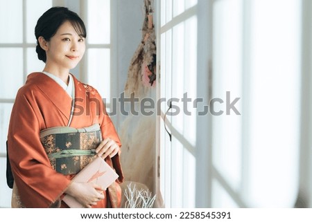 Asian woman in Japanese kimono. Commemorative photo in Japanese clothes. Photo studio.