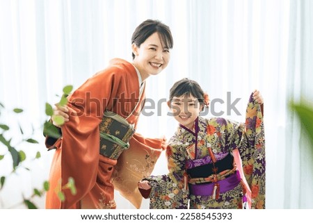 Mother and daughter in Japanese kimono. Commemorative photo in Japanese clothes. Photo studio.