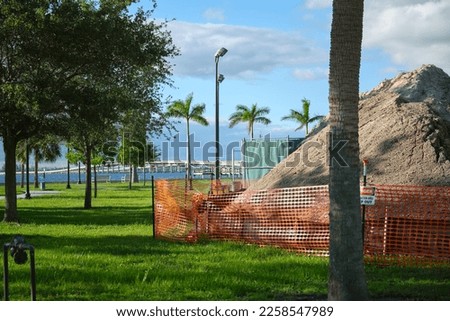 Protective restriction barrier at industrial construction site. Safety mesh fence for pedestrians