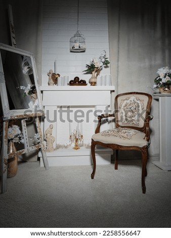 Old style room interior by fireplace with vintage armchair Royalty-Free Stock Photo #2258556647