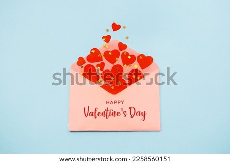 Saint Valentine day holiday background with envelope, paper card and various red hearts for love romantic message. Flat lay composition