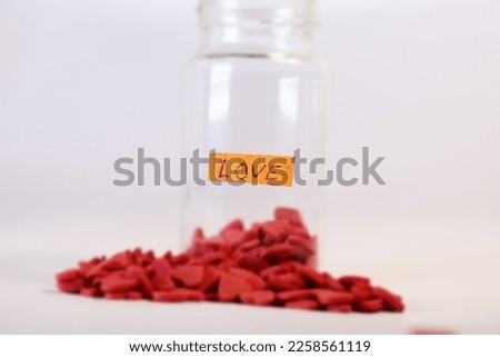 Medical bottle full of red hearts on white background, healthcare and love concept. Valentine's day. Love pills. Royalty-Free Stock Photo #2258561119