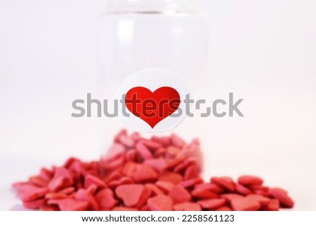 Medical bottle full of red hearts on white background, healthcare and love concept. Valentine's day. Love pills.