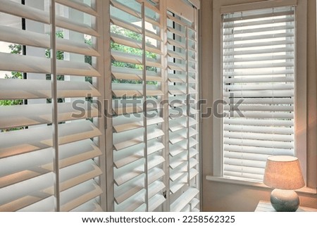 Wooden window shutters in modern interiors  Royalty-Free Stock Photo #2258562325