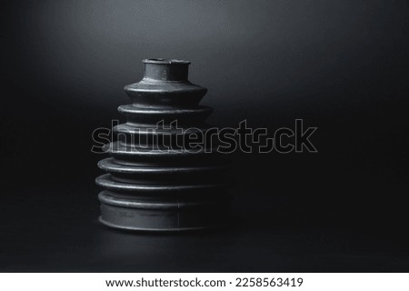 Close-up of a rubber boot on a CV joint on a black background in selective focus Royalty-Free Stock Photo #2258563419
