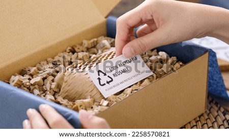 Eco vendor go green packaging parcel carton box in net zero waste store asian seller retail shop. Earth care day small SME owner asia people wrap reuse brown paper pack gift reduce plastic free order. Royalty-Free Stock Photo #2258570821