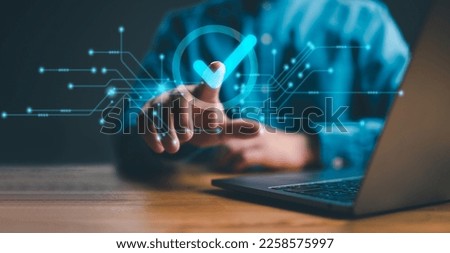 service guarantee, Validation concept for business process automation, quality assurance management, certification, digital transformation. businessman touching checked icon on virtual screen. Royalty-Free Stock Photo #2258575997