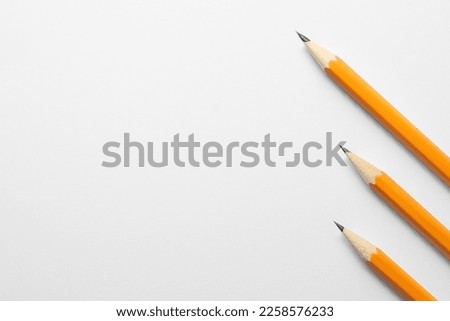 Sharp graphite pencils on white background, flat lay. Space for text