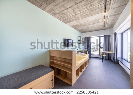 Simple student-style dorm bedroom. Hostel dormitory room. Campus Royalty-Free Stock Photo #2258585421