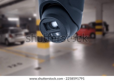 CCTV camera in underground parking garage. Copy space