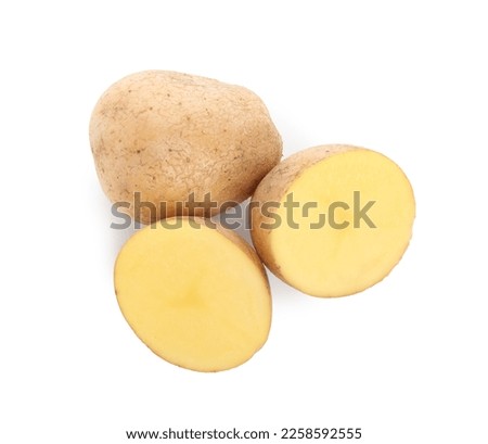 Whole and cut fresh potatoes on white background, top view
