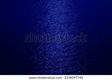 blue texture background and moving water waves and natural light sparkles