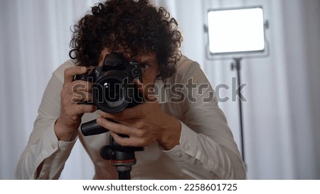 Italy, Milan - Real estate photographer man taking professional pictures and video of the bedroom for real estate agency - home staging to sell the house - renting a home for tourist  traveller