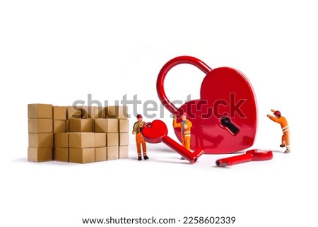 miniature workers with heart shape padlock isolated on white background.