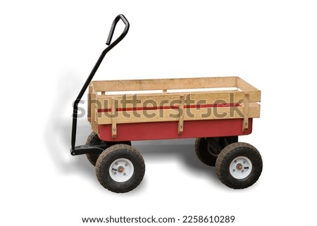 Little red farm wood wagon isolated on white background. This has clipping path.  Royalty-Free Stock Photo #2258610289