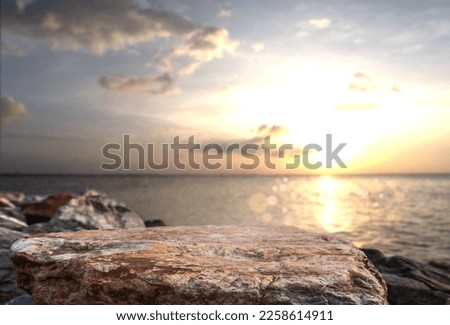 Rock stone stage in nature with sea beach seashore landscape and sunset summer sky nature Backgrounds well editing montage Displays product