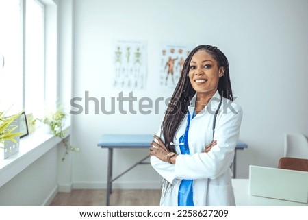 Medical Doctor Indoors Portraits. Portrait of a confident doctor working at a hospital. Waist up portrait of beautiful African-American nurse posing confidently while standing with arms crossed