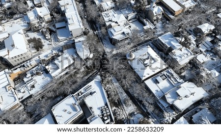 Aerial drone photo of main commercial centre of Kifisia district covered in snow during winter time, North Athens, Attica, Greece