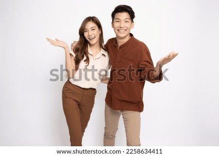 Happy Asian couple presenting or showing open hand palm with copy space for product isolated over white background