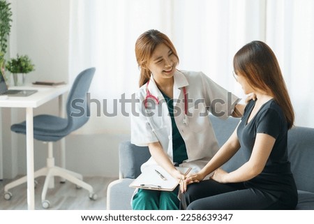 Asian female doctor asks about the patient's condition and makes recommendations about medications and disease treatment. Royalty-Free Stock Photo #2258639347